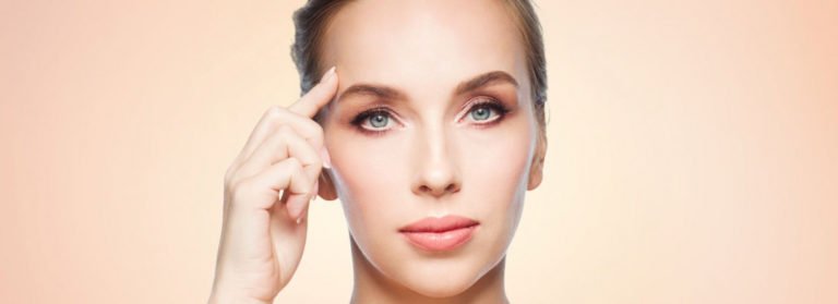 Girl holding her finer on forehead | Get Botox on Beauty Boost Med Spa in Newport Beach, CA