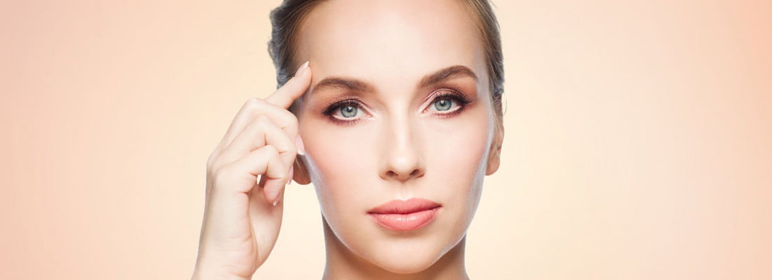 Girl holding her finer on forehead | Get Botox on Beauty Boost Med Spa in Newport Beach, CA