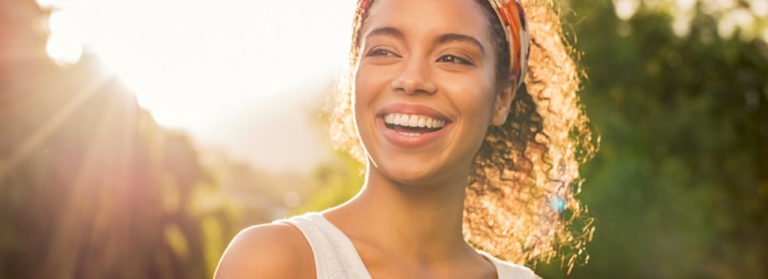 Portrait of A Smiling women in sunny background | Dermal Fillers in Beauty Boost Med Spa at Newport Beach, CA