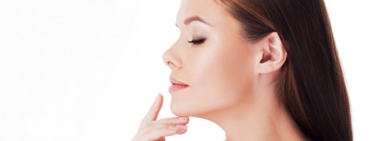 Gorgeous lady with closed eyes and holding hand on near neck | Beauty Boost Med Spa at Newport Beach, CA