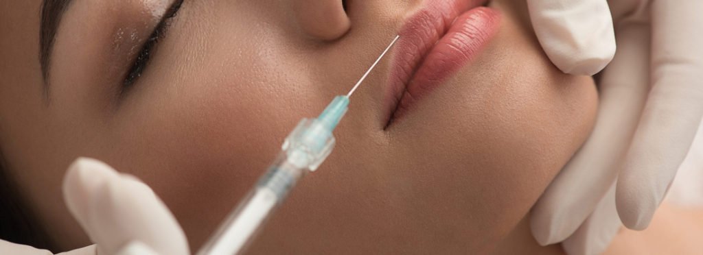 A Women getting injection to lips | Get Booty Boost treatment in Beauty Boost Med Spa at Newport Beach, CA