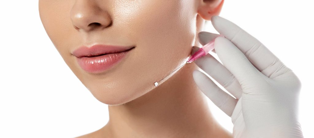 A Lady getting injection on jawline | Get Botox Cosmetic / Dysport in Beauty Boost Med Spa at Newport Beach, CA