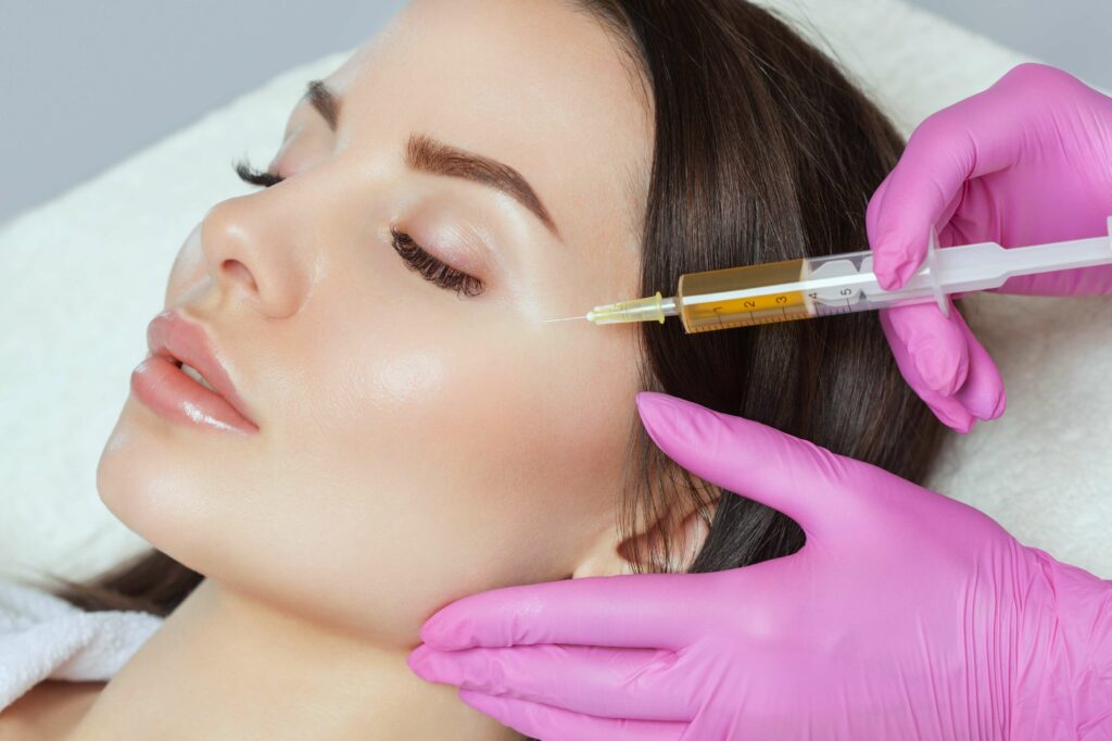Portfolio 229 The pretty lady receiving injection near eye | Collagen Stimulators in Beauty Boost Med Spa at Newport Beach, CA