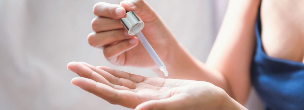 A Lady getting product drops on her hand | ZO Skin Health Products | Beauty Boost Med Spa at Newport Beach, CA