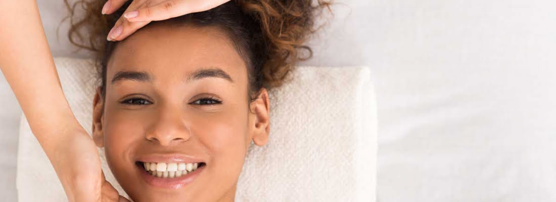 A Girl with curly hair smiling | Get beauty treatments in Beauty Boost Med Spa at Newport Beach, CA